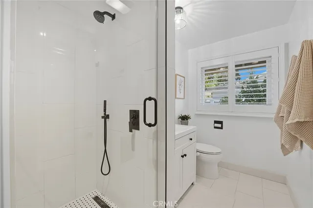 a bathroom with a sink a toilet and a window