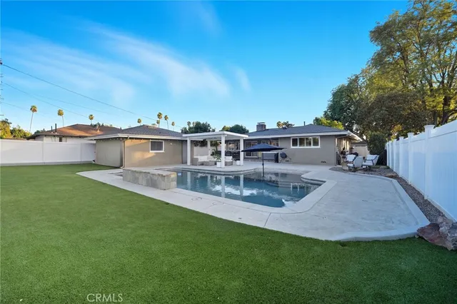 a view of a house with backyard sitting area and tub