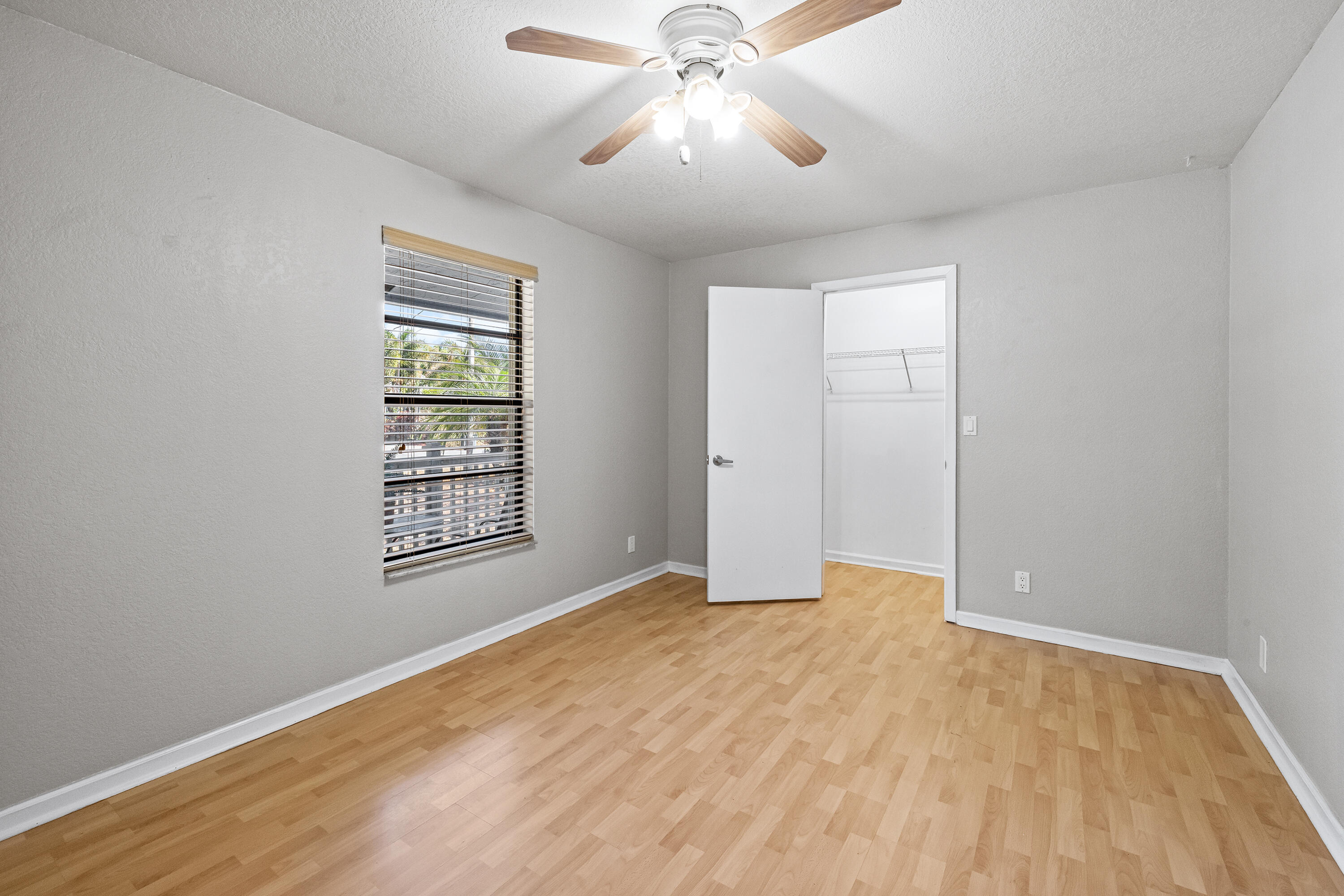 15400 76th Road North Loxahatchee, FL 33470 - Photo 16 of 39 wooden floor in an empty room with a window