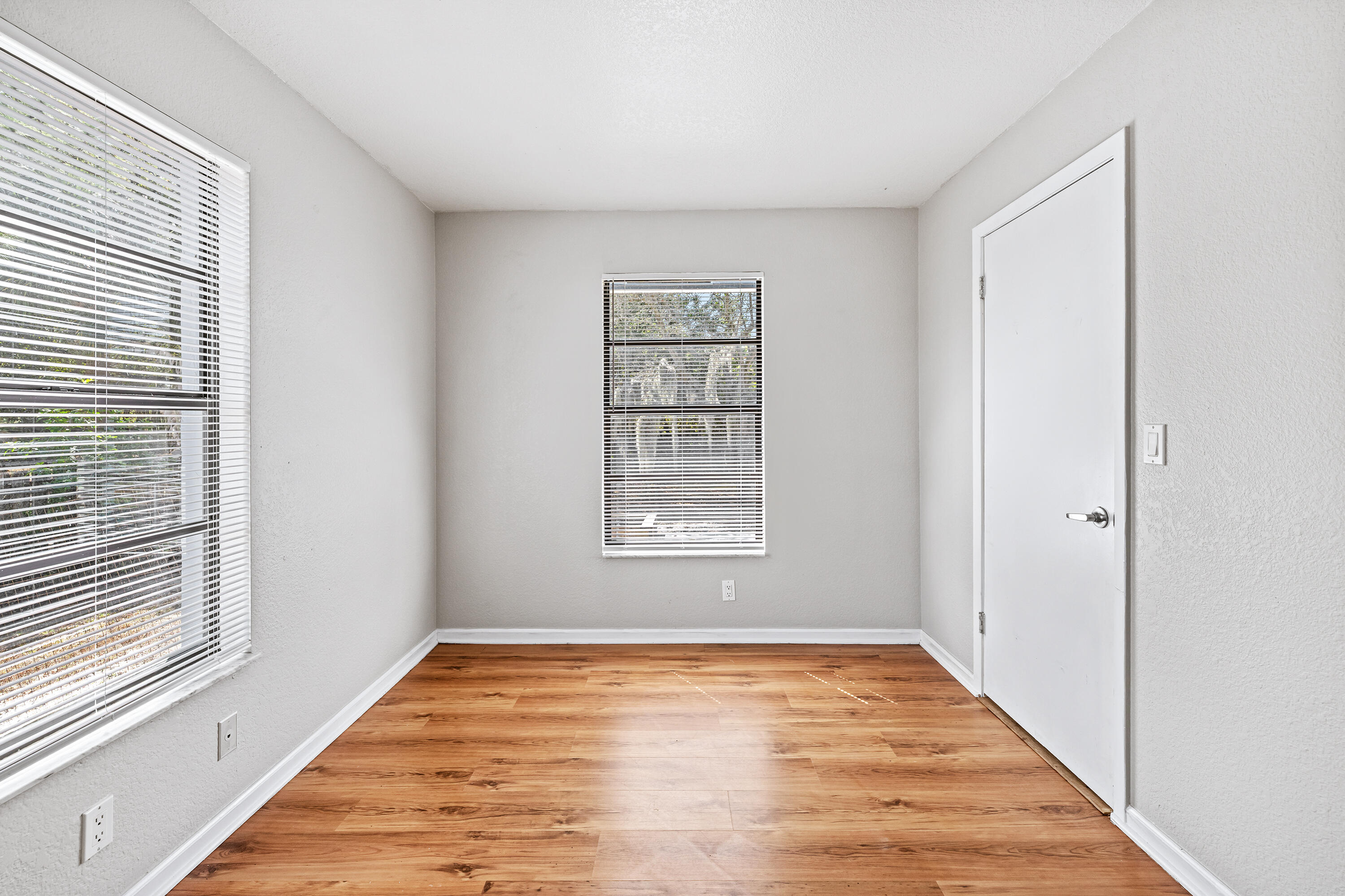 15400 76th Road North Loxahatchee, FL 33470 - Photo 21 of 39 a view of an empty room with wooden floor and a window