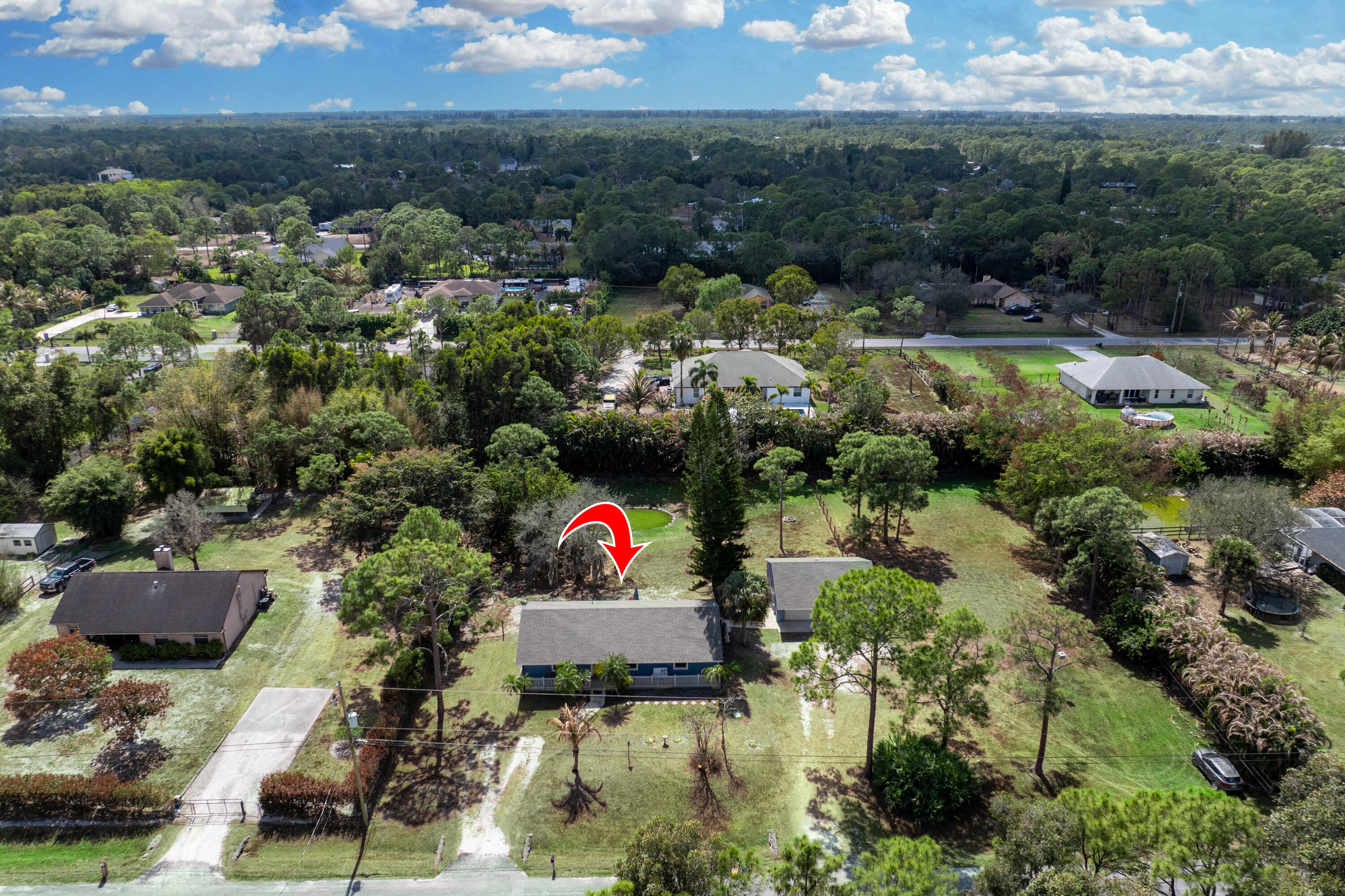 15400 76th Road North Loxahatchee, FL 33470 - Photo 37 of 39 a view of a back yard of the house and swimming pool