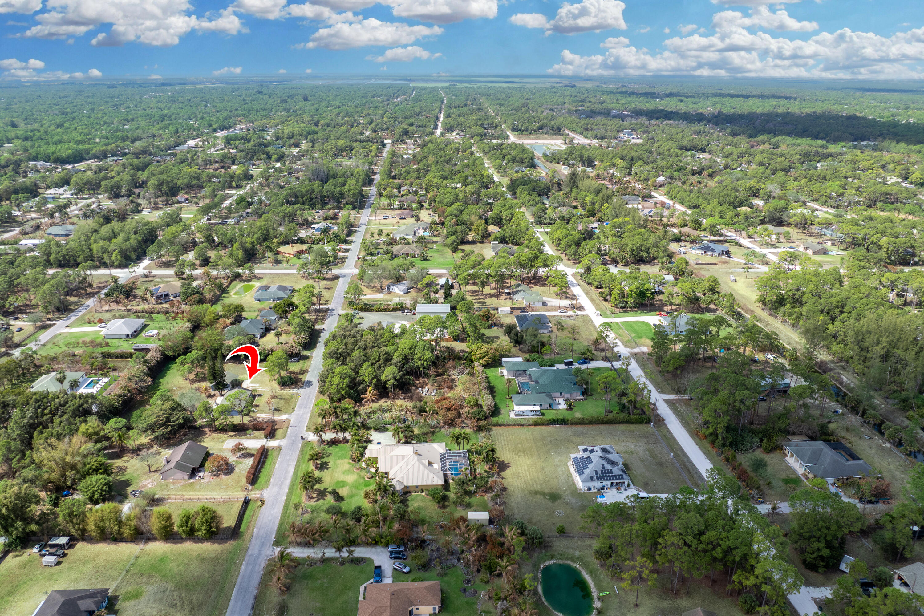15400 76th Road North Loxahatchee, FL 33470 - Photo 38 of 39 an aerial view of residential houses with outdoor space and trees