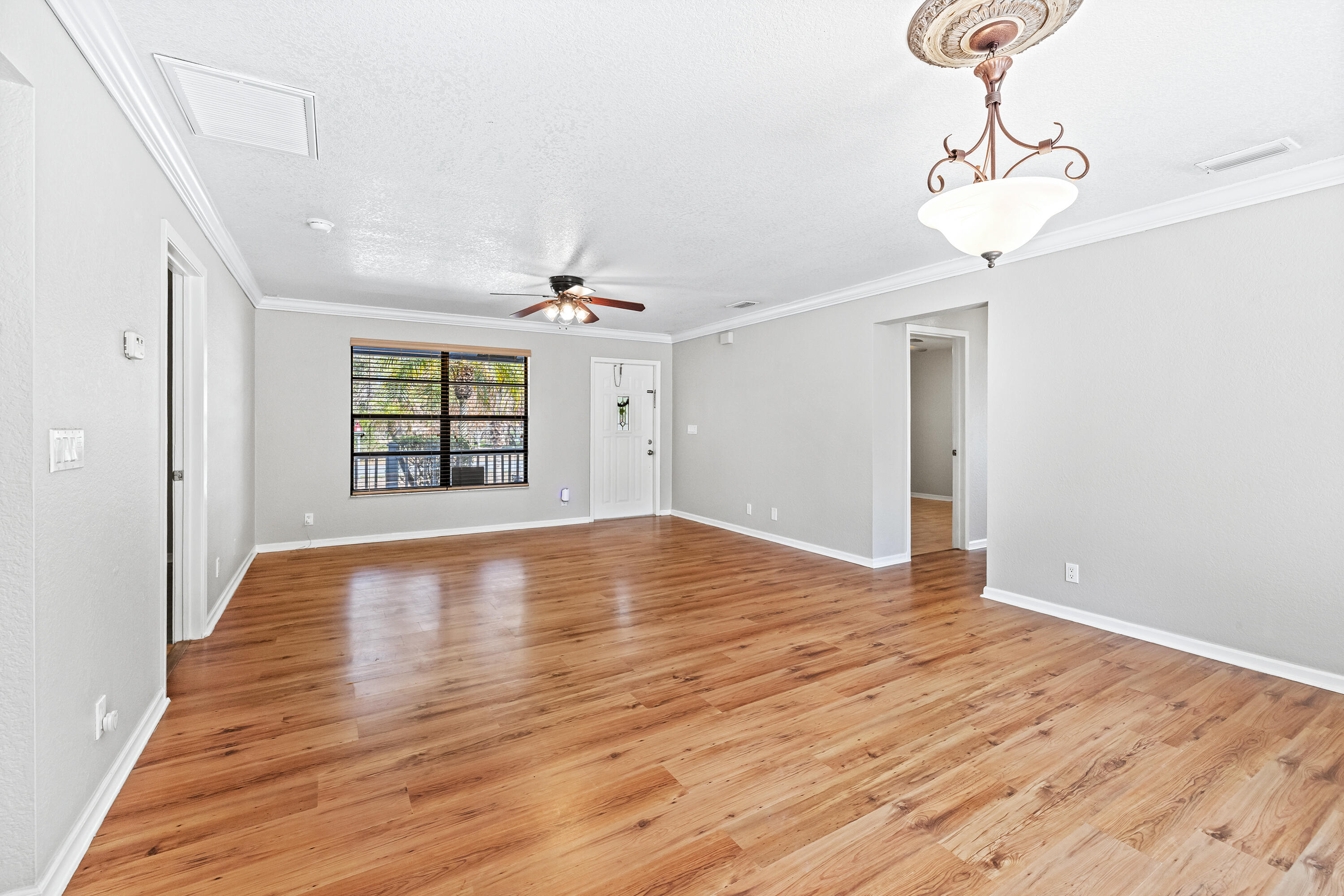 15400 76th Road North Loxahatchee, FL 33470 - Photo 5 of 39 a view of empty room with wooden floor and fan