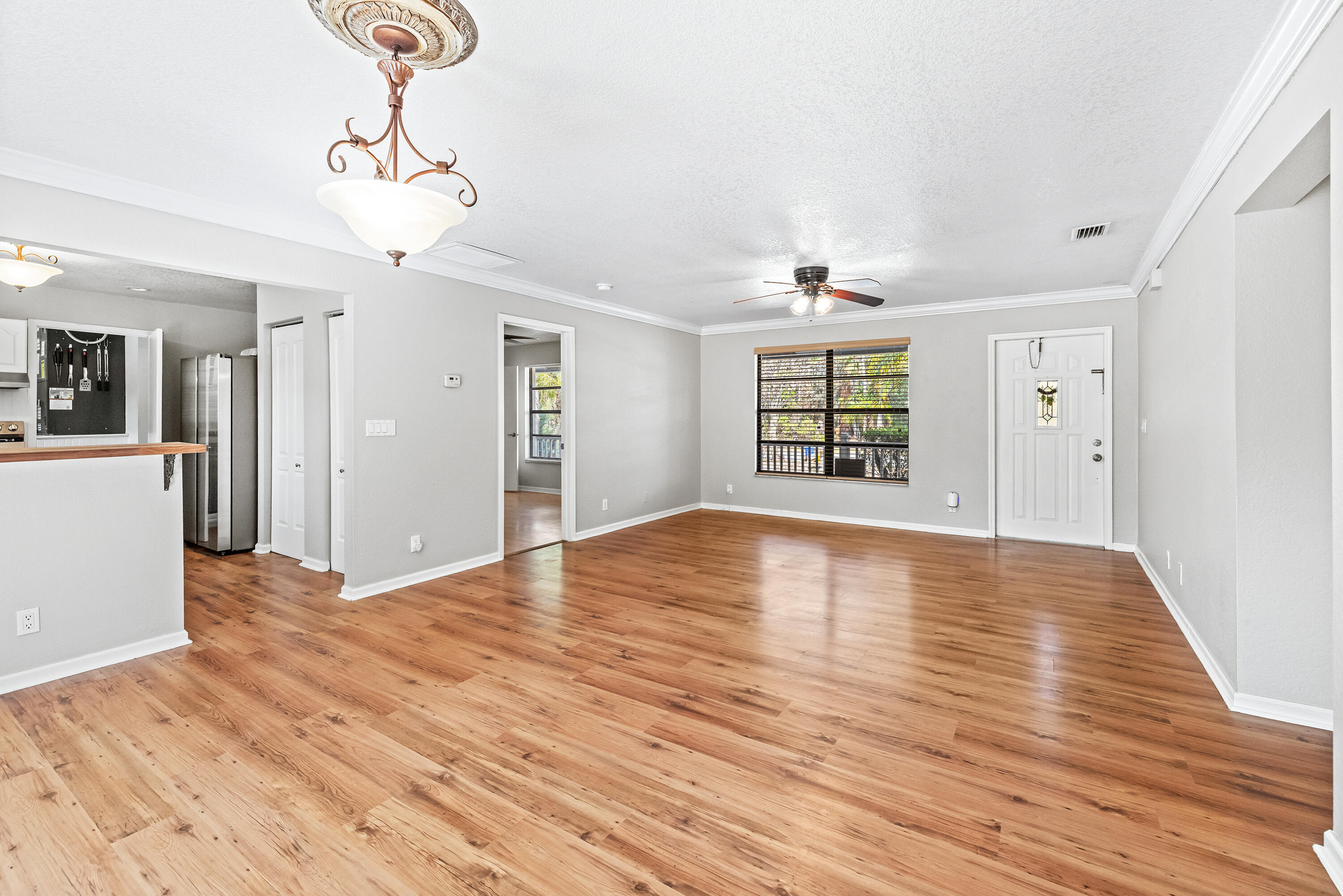 15400 76th Road North Loxahatchee, FL 33470 - Photo 7 of 39 a view of an empty room with wooden floor and a window