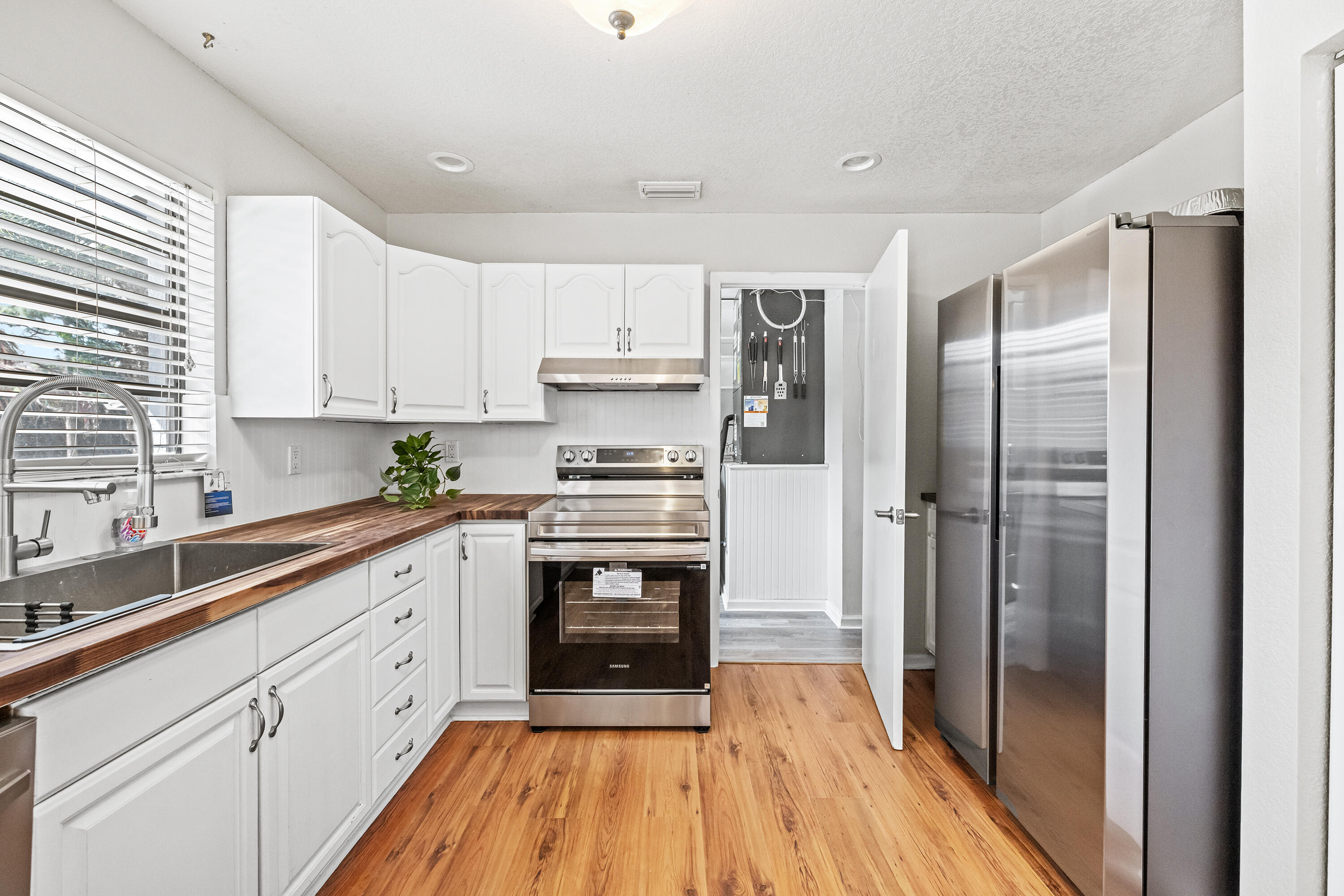 15400 76th Road North Loxahatchee, FL 33470 - Photo 8 of 39 a kitchen with stainless steel appliances a refrigerator sink and cabinets