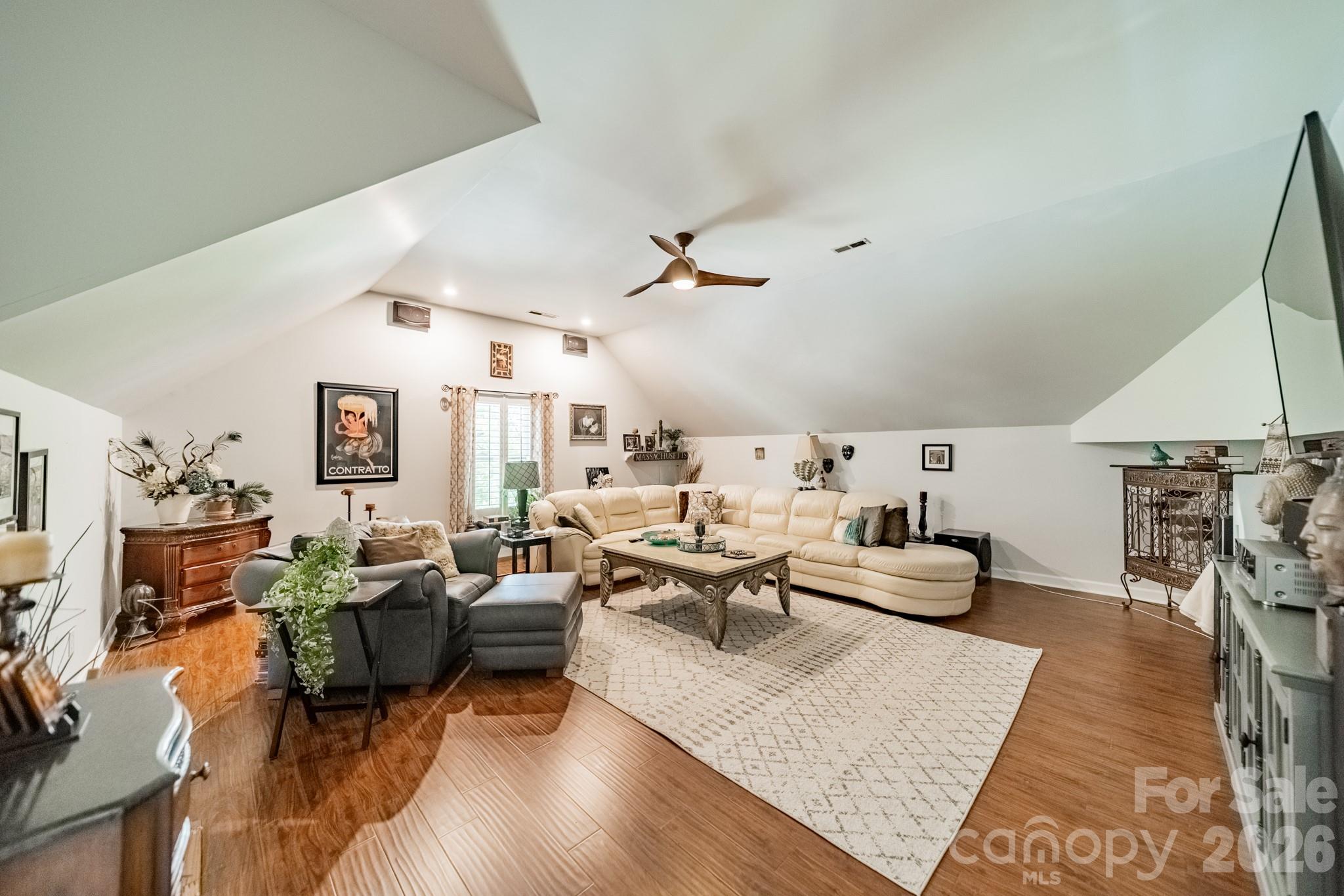 11043 Seven Coves Drive Tega Cay, SC 29708 - Photo 35 of 45 a living room with furniture and a wooden floor