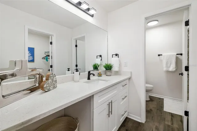 a bathroom with a double vanity sink toilet and shower