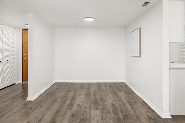 a view of room with wooden floor and window
