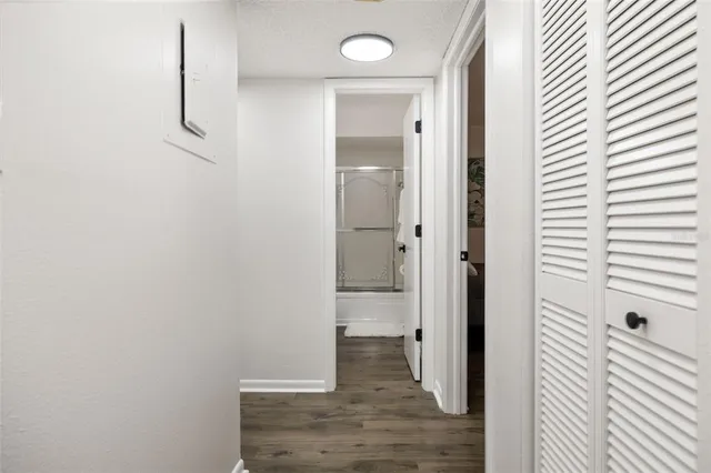a view of a room with wooden floor and windows