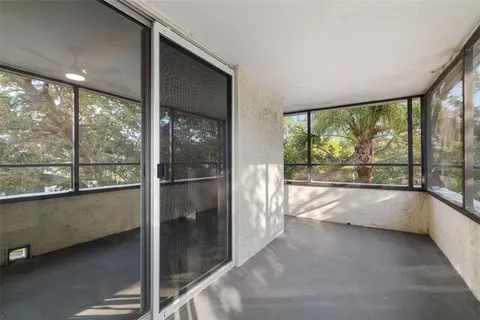 a room with pool table and windows