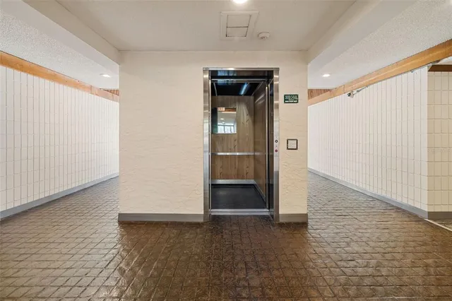 a living room with lots of furniture and a large window