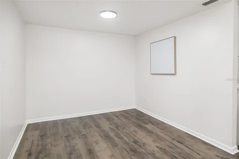 a kitchen with white cabinets and refrigerator