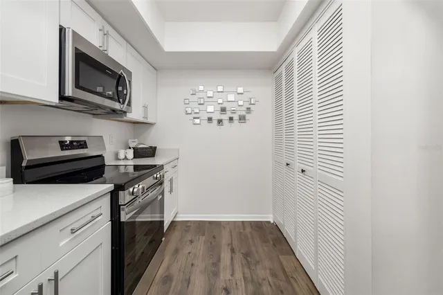 a view of a livingroom with wooden floor and a ceiling fan