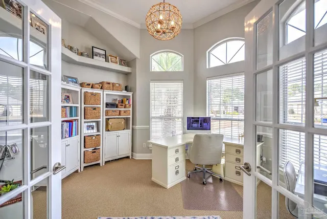 a bedroom with a bed table and a book shelf