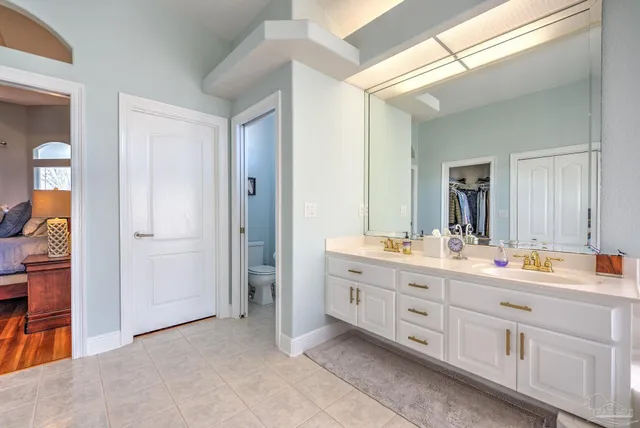 a bedroom with a bed and a wooden floor