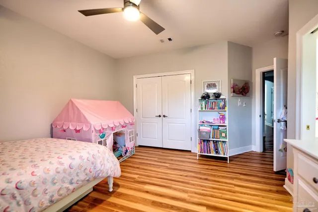 a view of a swimming pool with lawn chairs under an umbrella