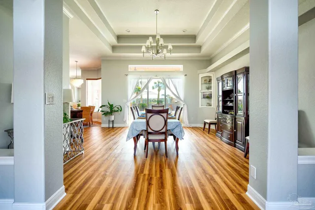 a view of a dining room with furniture and wooden floor