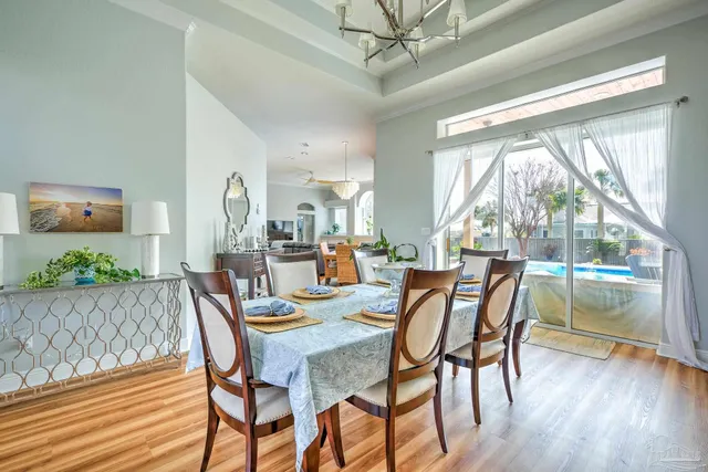 a view of a dining room with furniture and a large window