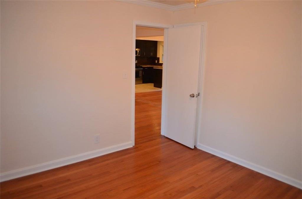 1329 Westridge Road Southwest Atlanta, GA 30311 - Photo 36 of 54 a view of an empty room with wooden floor and closet