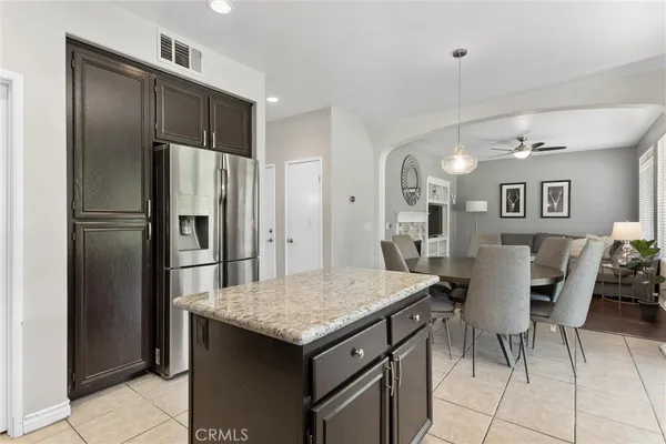 a kitchen with a refrigerator a table and chairs