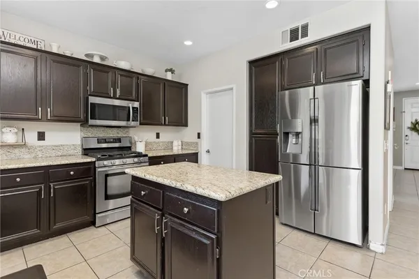 a kitchen with a refrigerator sink and microwave