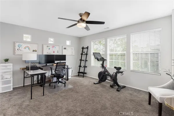 a view of a livingroom with workspace and a window