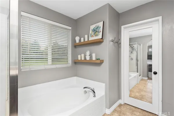 a bathroom with bathtub and window