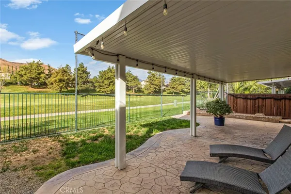 a view of a deck with a table chairs and a backyard
