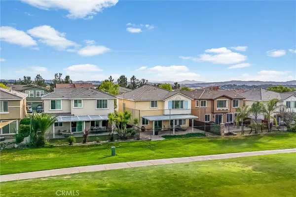 an aerial view of residential houses with outdoor space and swimming pool