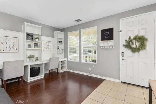 a view of a house with workspace and wooden floor