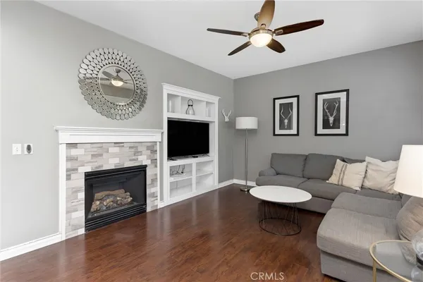 a living room with furniture a fireplace and a flat screen tv