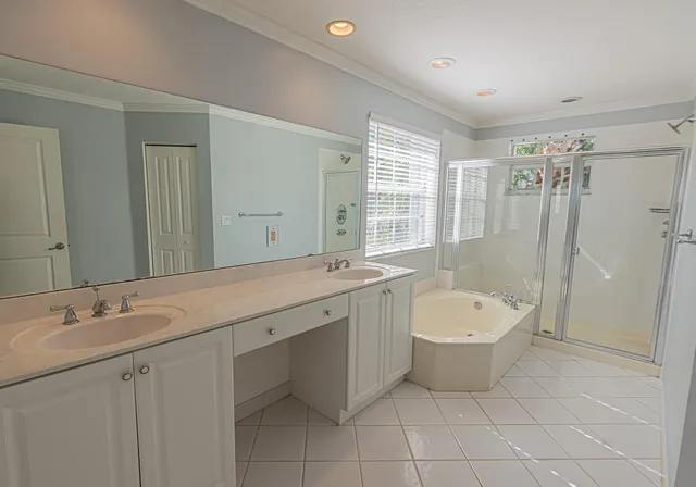 a spacious bathroom with a double vanity sink mirror and toilet