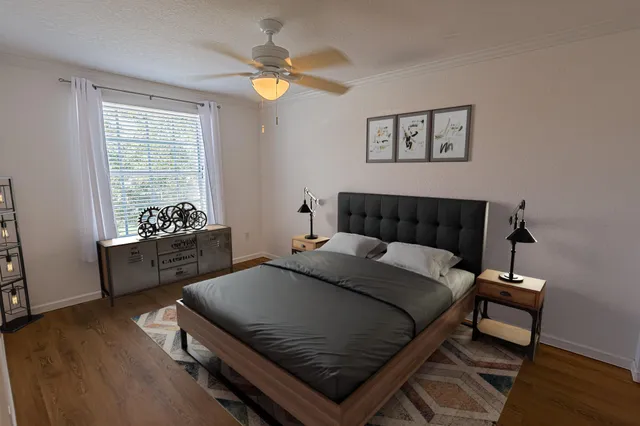 a bedroom with a bed and a chandelier