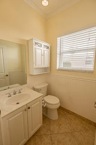 a bathroom with a sink a toilet and a window