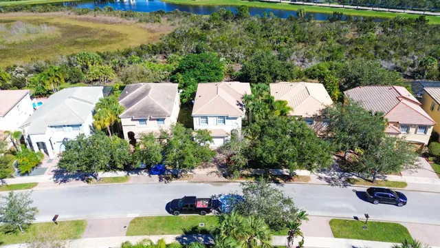 an aerial view of residential houses with outdoor space and swimming pool
