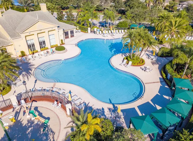 a view of a swimming pool with outdoor seating