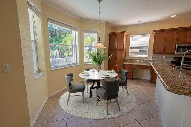 a kitchen with granite countertop sink dining table and chairs