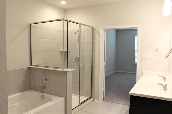 a bathroom with a bathtub a sink and a shower