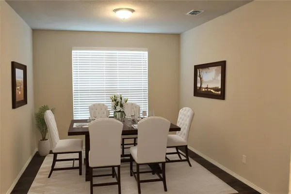 a view of a dining room with furniture and window