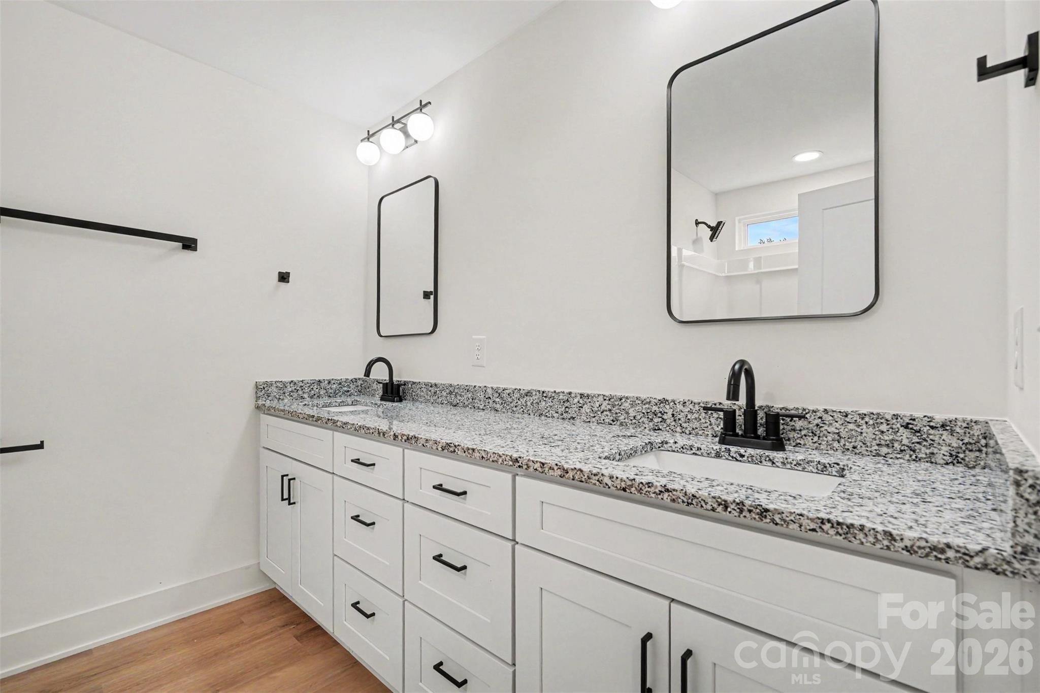 7521 Lawyers Road Charlotte, NC 28227 - Photo 24 of 35 a bathroom with a granite countertop sink mirror and vanity