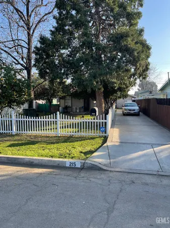 a view of a house with a yard and sitting area