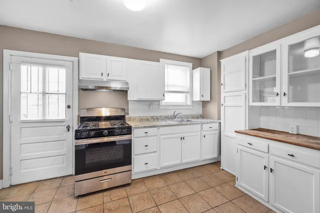 a kitchen with a stove and a refrigerator