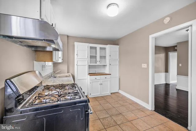 a open kitchen with white cabinets and stainless steel appliances