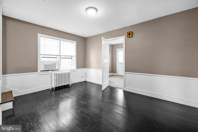 a view of room with window and wooden floor