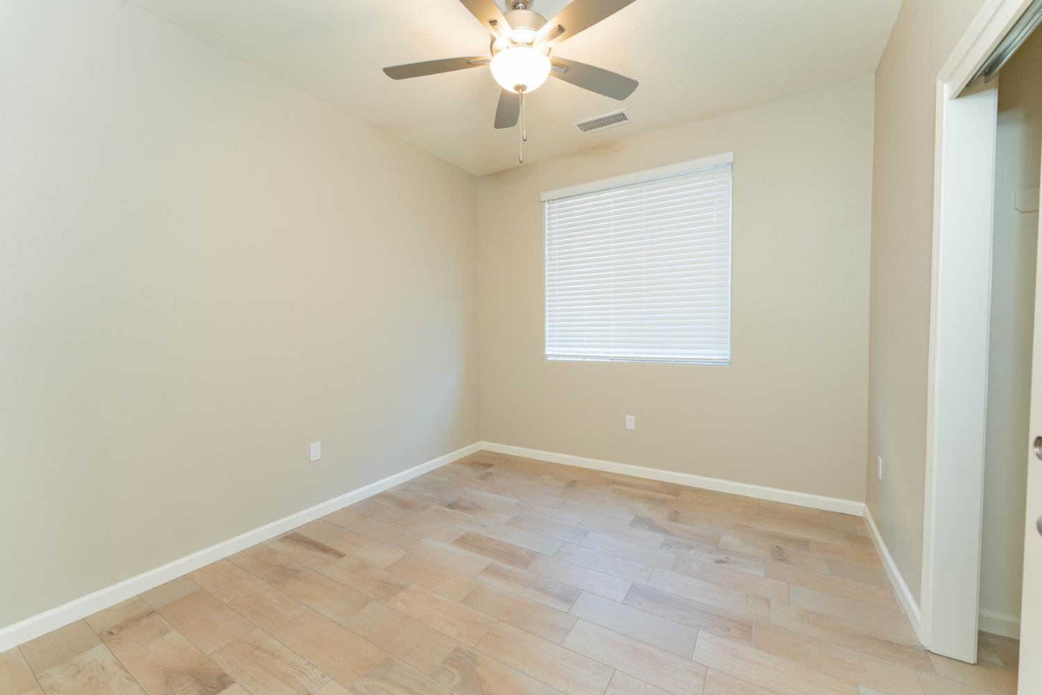 30480 Bellwood Road Visalia, CA 93291 - Photo 25 of 37 an empty room with a window and a fan
