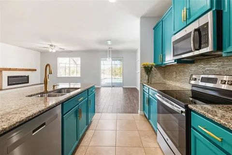 a kitchen with stainless steel appliances granite countertop a refrigerator and a stove