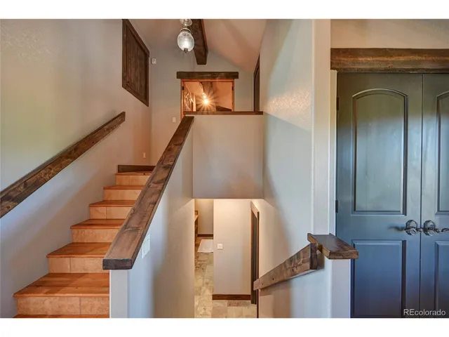 a bathroom with a granite countertop toilet and a sink