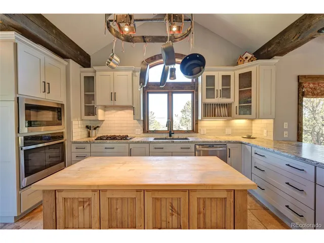 a kitchen with a wooden floor and cabinets