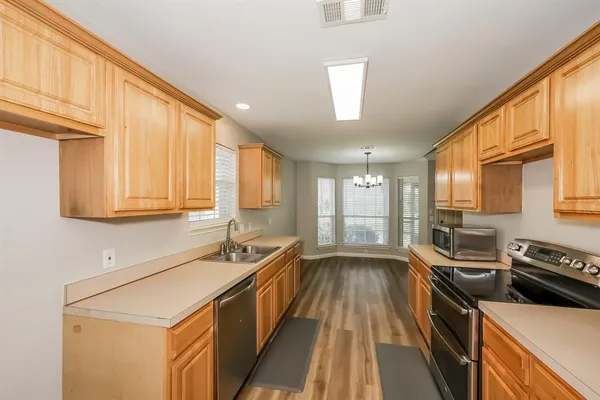 a kitchen that has a sink and a stove