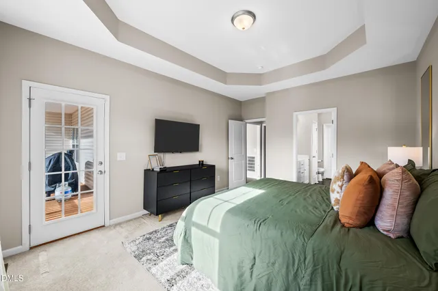 a bedroom with a large bed and a flat screen tv